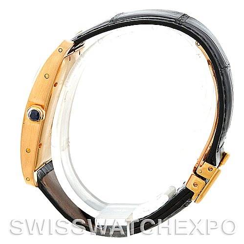 This image shows a Cartier Tank Americaine W2603156 Men's Yellow Gold Silver Dial W2603156 Men's Yellow Gold Silver Dial watch viewed from the side, highlighting its case, crown, and leather strap.