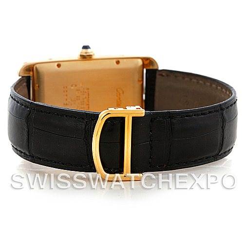 The image shows the back view of a Cartier Tank Americaine W2603156 Men's Yellow Gold Silver Dial W2603156 Men's Yellow Gold Silver Dial model watch, focusing on its buckle and leather strap.