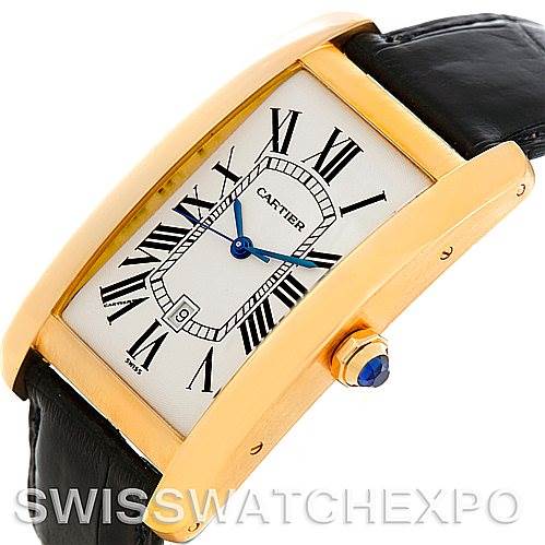 The image shows a close-up, angled view of the Cartier Tank Americaine W2603156 Men's Yellow Gold Silver Dial W2603156 Men's Yellow Gold Silver Dial watch, highlighting its gold case, blue hands, and black leather strap.