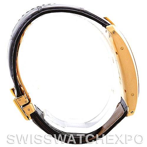 The image shows a Cartier Tank Americaine W2603156 Men's Yellow Gold Silver Dial W2603156 Men's Yellow Gold Silver Dial watch in a side profile, highlighting its gold case and brown leather strap.