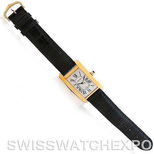 This image shows a top-down view of the Cartier Tank Americaine W2603156 Men
s Yellow Gold Silver Dial W2603156 Men
s Yellow Gold Silver Dial watch, highlighting its rectangular face, gold casing, and black leather strap.