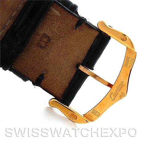 This image shows the gold clasp and part of the leather strap of a Tank Américaine watch by Cartier from a close-up angle.