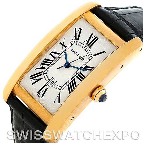 The image shows a Cartier Tank Americaine W2603156 Men
s Yellow Gold Silver Dial W2603156 Men
s Yellow Gold Silver Dial watch from an angled side view, highlighting the rectangular gold case, Roman numeral dial, and black leather strap.