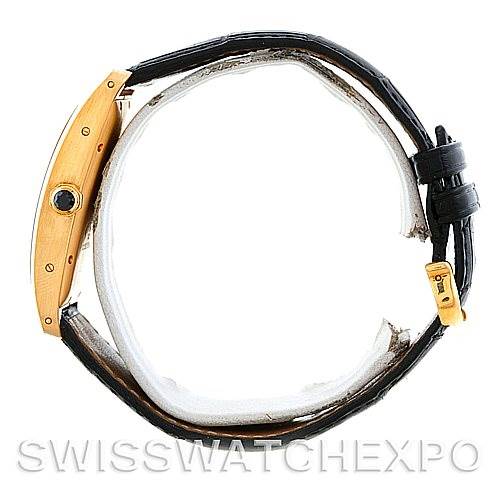 The Cartier Tank Americaine W2603156 Men
s Yellow Gold Silver Dial W2603156 Men
s Yellow Gold Silver Dial watch is shown in a side profile view, highlighting its rectangular case, crown, and black leather strap.