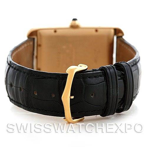 The image shows the Cartier Tank Americaine W2603156 Men
s Yellow Gold Silver Dial W2603156 Men
s Yellow Gold Silver Dial watch from the back, highlighting its leather strap and buckle.