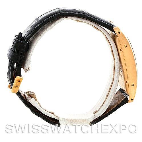 The image shows a Cartier Tank Americaine W2603156 Men
s Yellow Gold Silver Dial W2603156 Men
s Yellow Gold Silver Dial watch from a side angle, highlighting the strap and the side of the case.