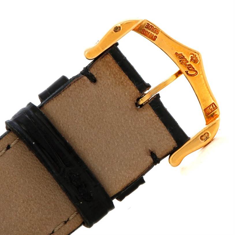 This image shows the golden buckle and part of the leather strap of a Cartier Tank Americaine W2603156 Men's Yellow Gold Silver Dial W2603156 Men's Yellow Gold Silver Dial watch.