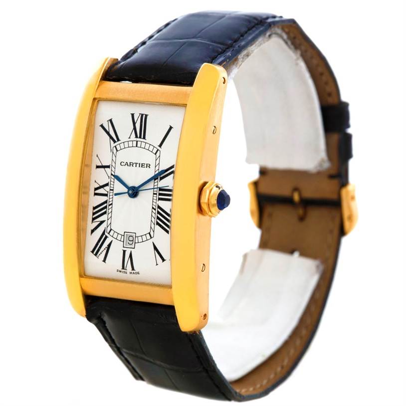The image shows a Cartier Tank Americaine W2603156 Men's Yellow Gold Silver Dial W2603156 Men's Yellow Gold Silver Dial watch at a three-quarter angle, showcasing its rectangular face, leather strap, and gold casing.