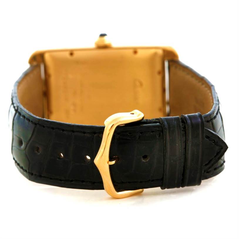 The image shows the back view of the Cartier Tank Americaine W2603156 Men's Yellow Gold Silver Dial W2603156 Men's Yellow Gold Silver Dial watch, highlighting its black leather strap and gold buckle.