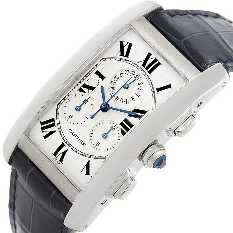 The image shows a close-up angled view of a Cartier Tank Americaine W2603358 Men's White Gold Silver Dial W2603358 Men's White Gold Silver Dial watch, highlighting its face, crown, and leather strap.