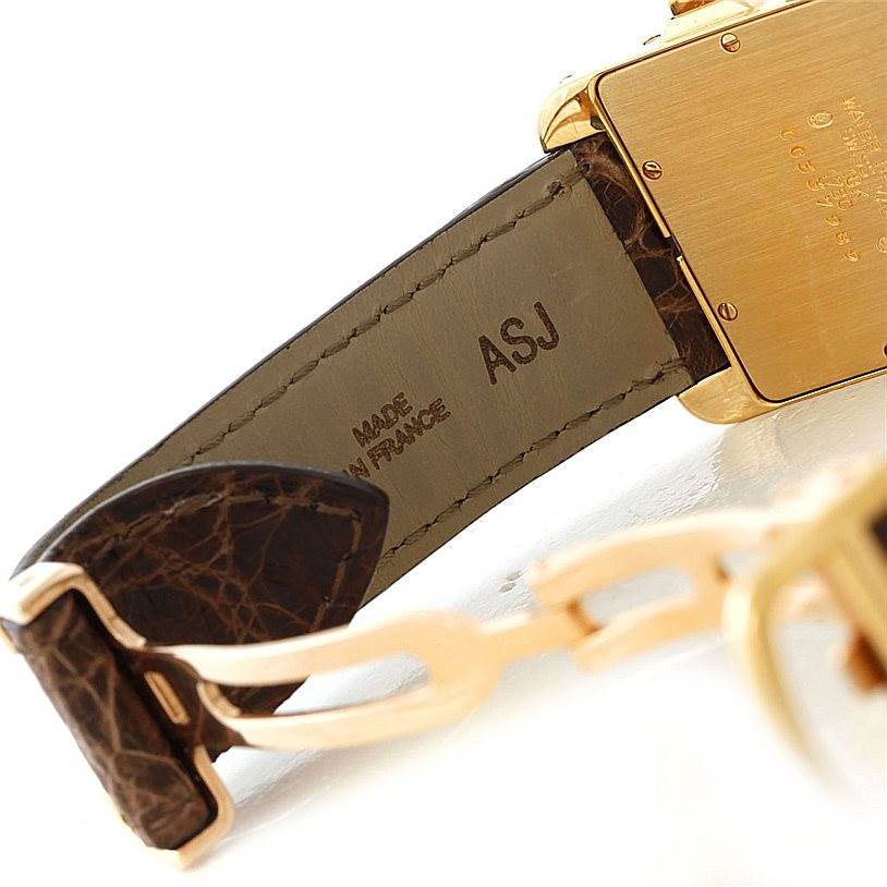 The image shows a close-up of the strap and back case of a Cartier Tank Americaine W2605856 Men's Yellow Gold Silver Dial W2605856 Men's Yellow Gold Silver Dial watch.