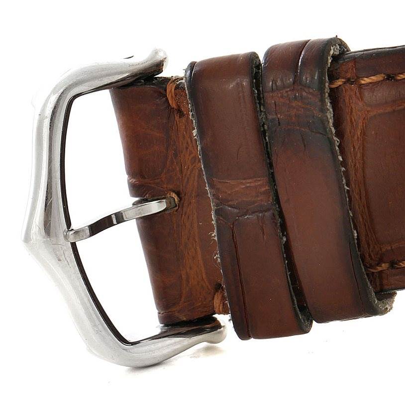 This image shows a close-up of the leather strap and buckle of the Cartier Tank Americaine W2603256 Men's White Gold Silver Dial W2603256 Men's White Gold Silver Dial watch.