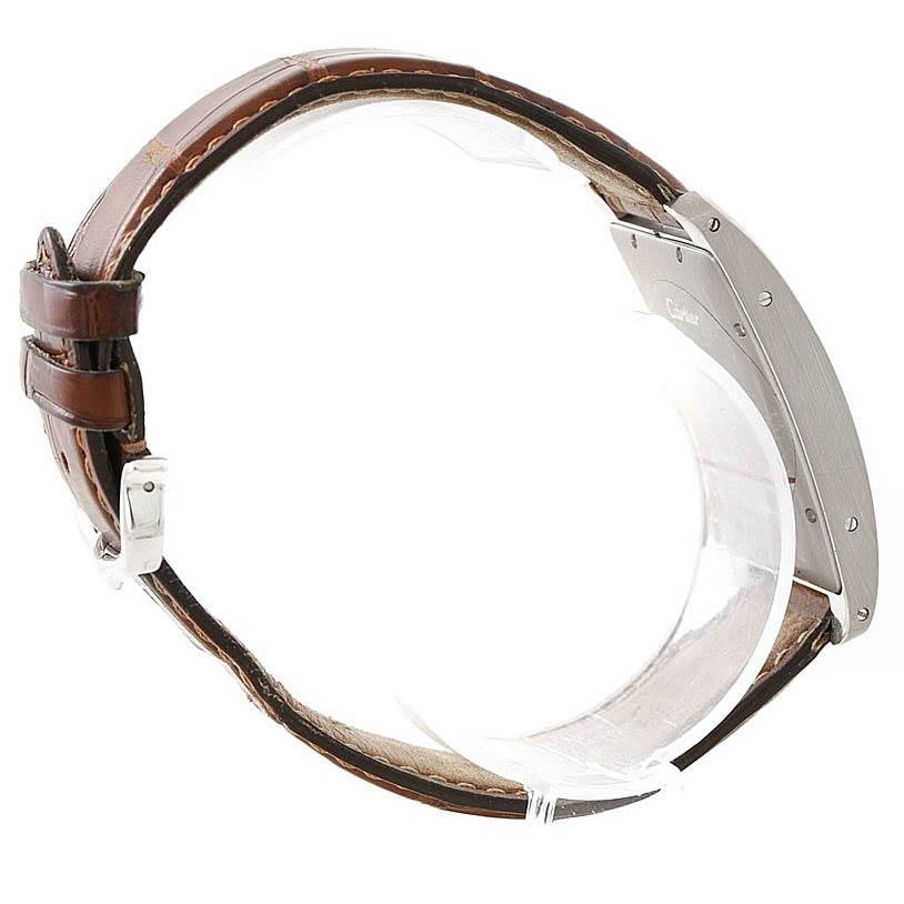 The image shows a side profile view of the Tank Americaine watch by Cartier, highlighting its brown leather strap and metal case.