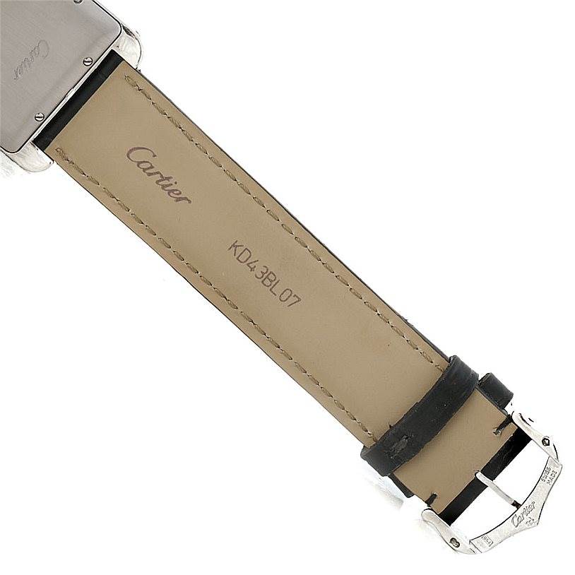 The image shows the backside of the strap and clasp of a Cartier Tank Americaine W2603256 Men
s White Gold Silver Dial W2603256 Men
s White Gold Silver Dial watch.