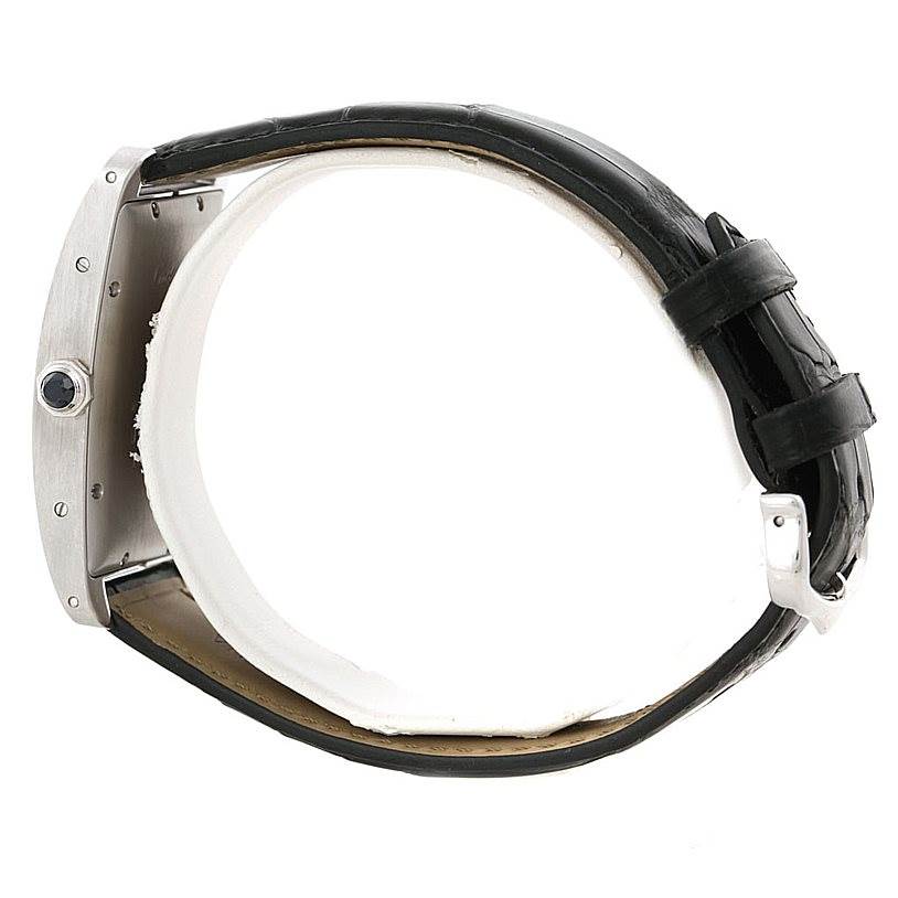 The Tank Americaine model by Cartier is shown from a side angle, highlighting the case and black leather strap.