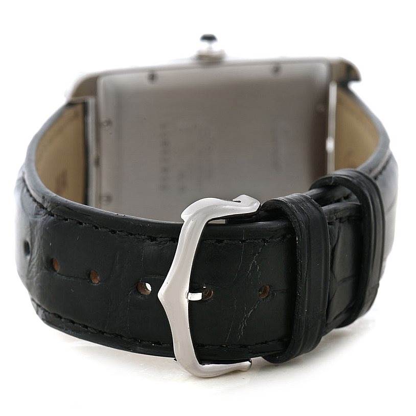 This image shows the rear view of the Tank Americaine watch by Cartier, focusing on the black leather strap and silver buckle.