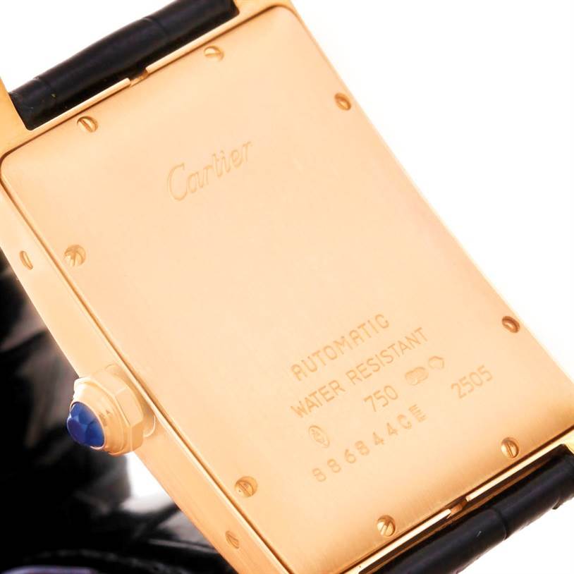 The image shows the back case of a Cartier Tank Americaine W2609156 Men's Rose Gold Silver Dial W2609156 Men's Rose Gold Silver Dial watch, highlighting inscriptions and the strap attachment.