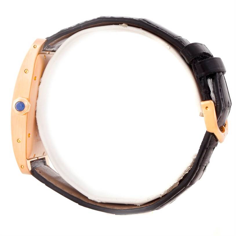 The image shows a side view of the Cartier Tank Americaine W2609156 Men's Rose Gold Silver Dial W2609156 Men's Rose Gold Silver Dial watch, highlighting its crown and leather strap.