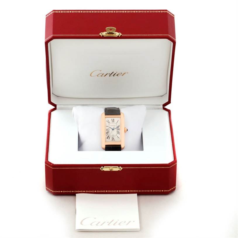 The Cartier Tank Americaine W2609156 Men's Rose Gold Silver Dial W2609156 Men's Rose Gold Silver Dial watch is shown head-on, inside a red jewelry box with a branded cushion and paperwork.