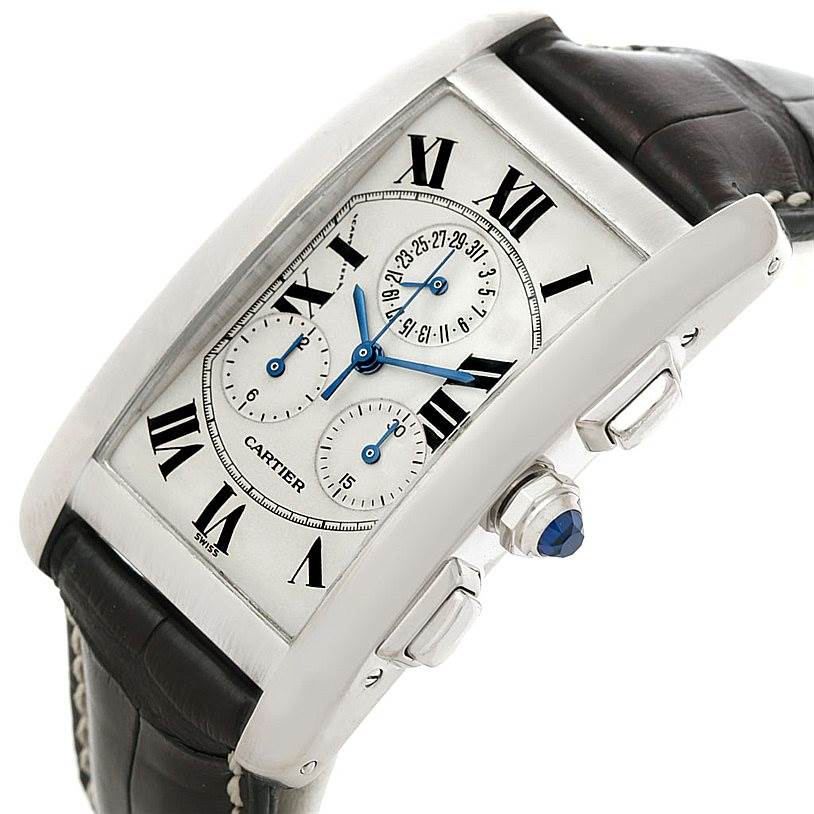 The image shows a Cartier Tank Americaine W2603358 Men's White Gold Silver Dial W2603358 Men's White Gold Silver Dial watch angled from the side, highlighting the dial, crown, and pushers.