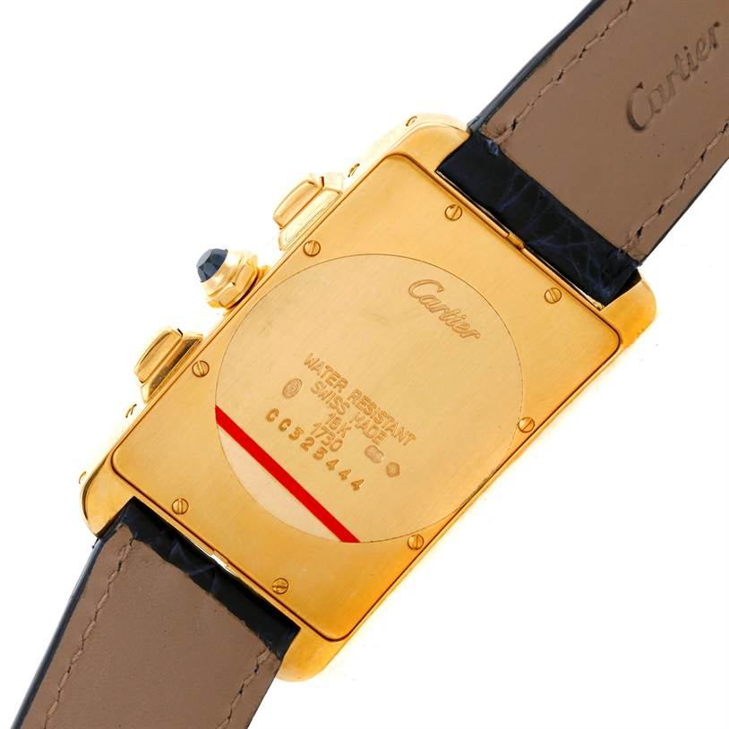 The image shows the back of a Cartier Tank Americaine W2601156 Men
s Yellow Gold Silver Dial W2601156 Men
s Yellow Gold Silver Dial watch, highlighting its golden case and leather strap.