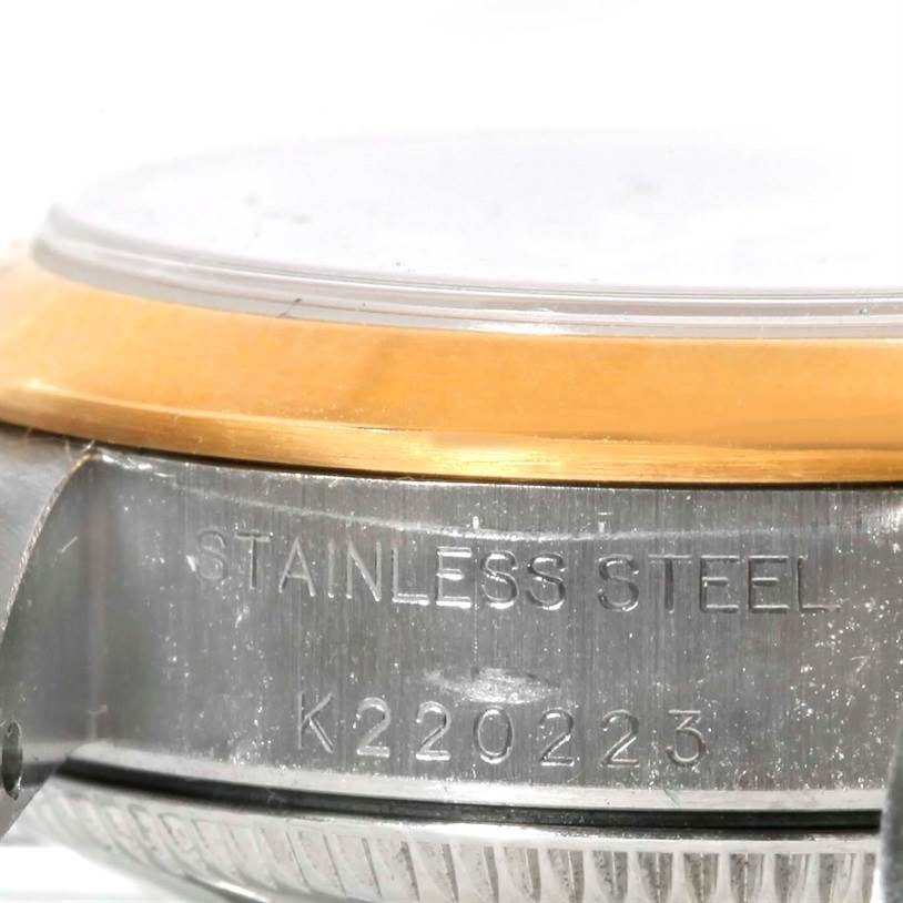This image shows a close-up side view of the case and bezel of a Rolex Oyster Perpetual 76183 Women's Steel and Gold (two tone) Grey Dial 76183 Women's Steel and Gold (two tone) Grey Dial watch, highlighting "STAINLESS STEEL" and the serial number.