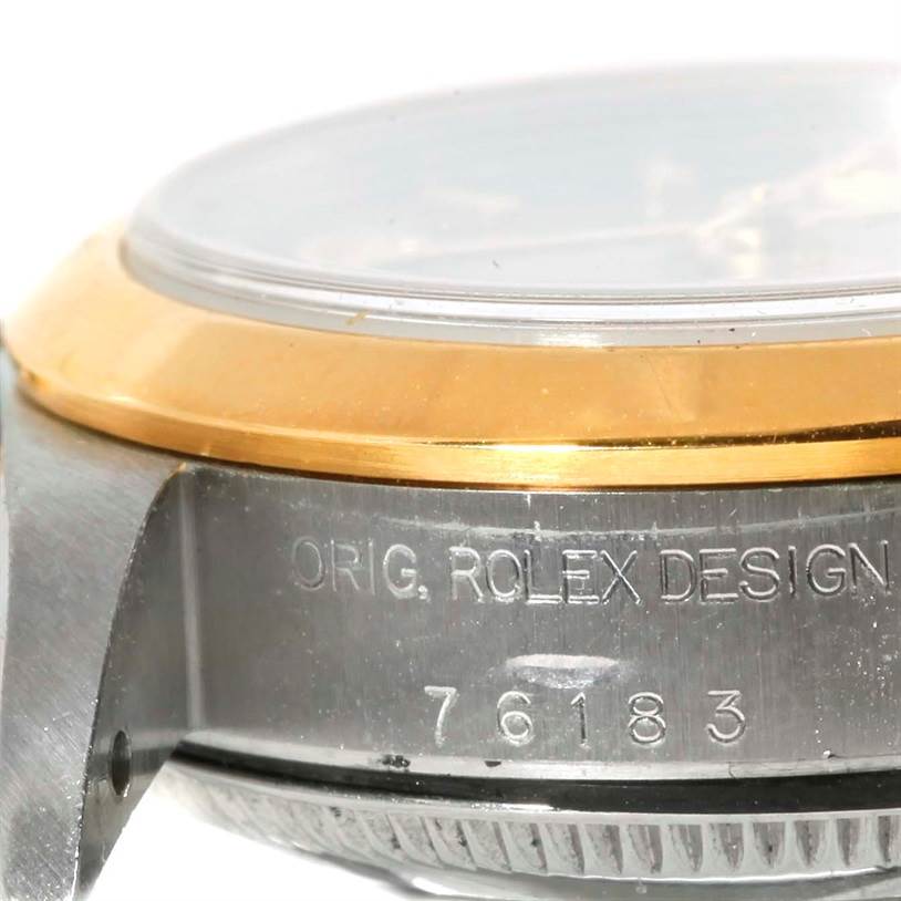Side view close-up of a Rolex Oyster Perpetual 76183 Women's Steel and Gold (two tone) Grey Dial 76183 Women's Steel and Gold (two tone) Grey Dial watch, showing the bezel, serial number, and "ORIG. ROLEX DESIGN" engraving.