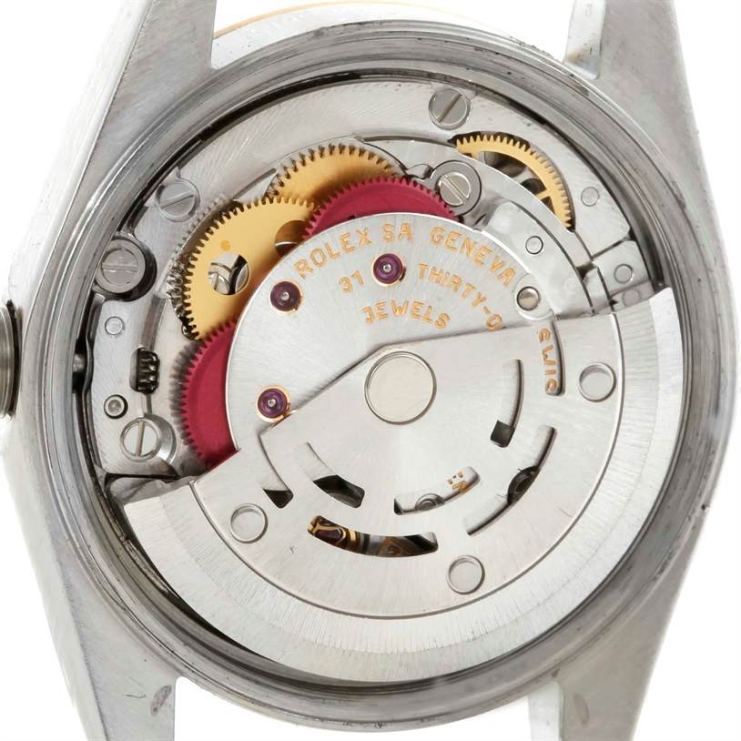 This image shows the back view of a Rolex Oyster Perpetual 76183 Women's Steel and Gold (two tone) Grey Dial 76183 Women's Steel and Gold (two tone) Grey Dial watch, revealing its internal movement and mechanical components.