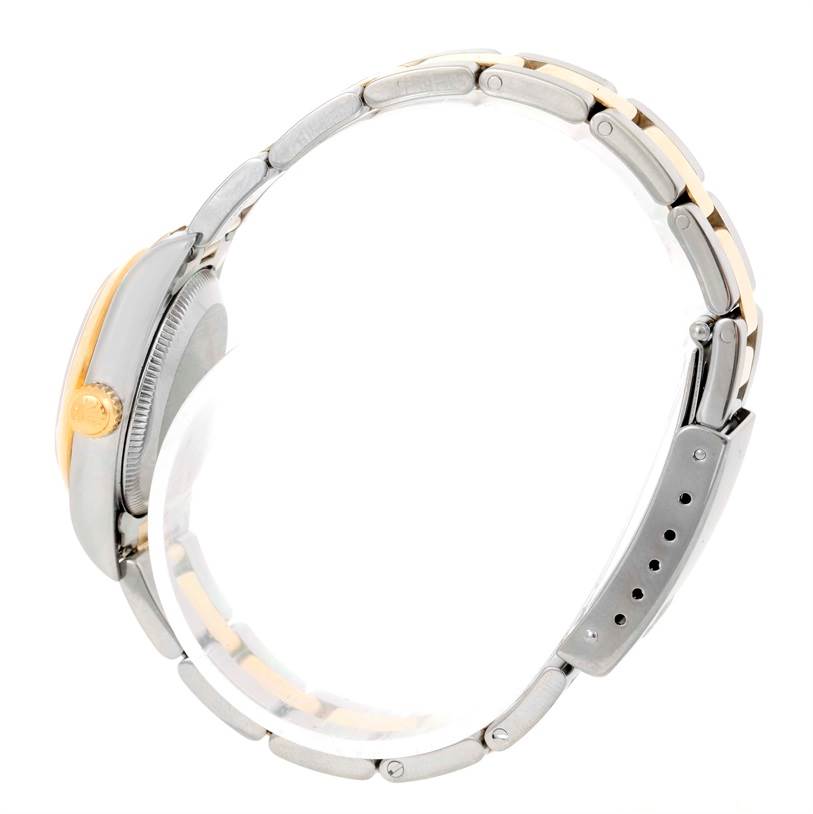 The image shows a side view of the Rolex Oyster Perpetual 76183 Women's Steel and Gold (two tone) Grey Dial 76183 Women's Steel and Gold (two tone) Grey Dial watch, featuring the crown and the bracelet with its clasp.