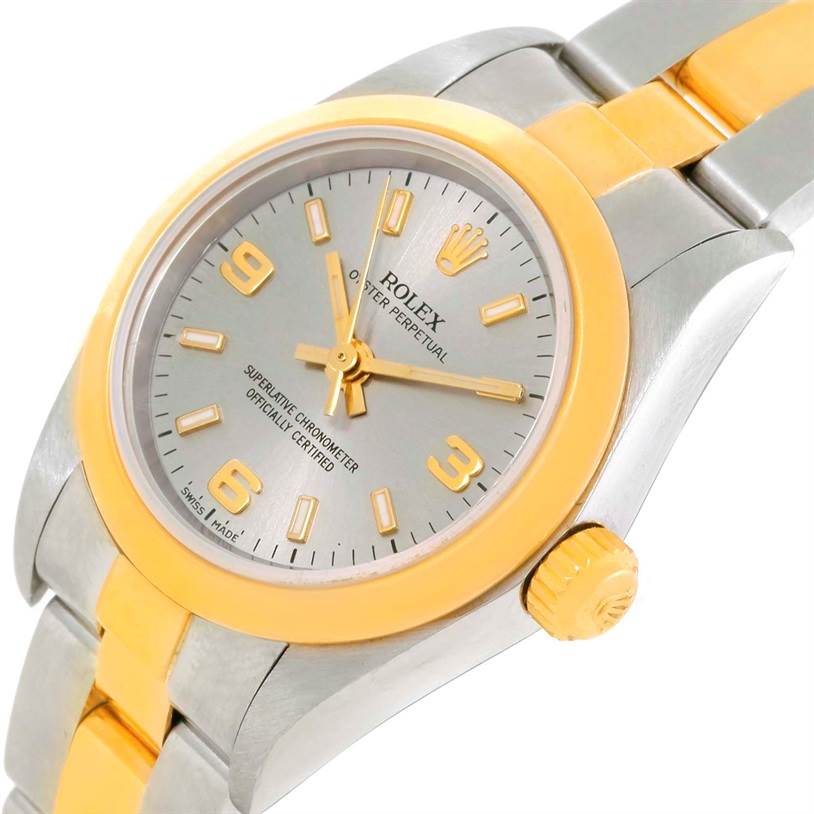 This image shows a close-up angle of the face, bezel, crown, and part of the bracelet of a Rolex Oyster Perpetual 76183 Women's Steel and Gold (two tone) Grey Dial 76183 Women's Steel and Gold (two tone) Grey Dial watch.