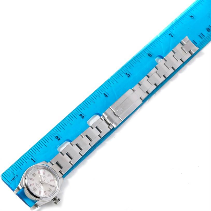 The image shows a Rolex Oyster Perpetual 176200 Women's Stainless Steel Silver Dial 176200 Women's Stainless Steel Silver Dial watch placed alongside a ruler, highlighting its dial, bracelet, and clasp.