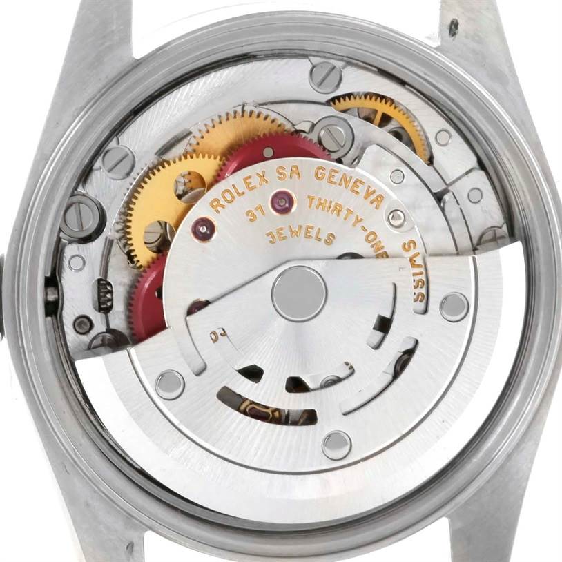 This image shows the internal mechanism of a Rolex Oyster Perpetual 76030 Women's Stainless Steel Pink Dial 76030 Women's Stainless Steel Pink Dial watch from a back angle, including gears and inscriptions.