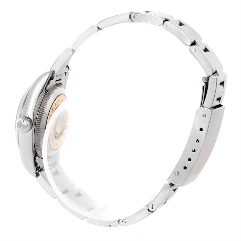 The image shows a side view of a Rolex Oyster Perpetual 76030 Women's Stainless Steel Pink Dial 76030 Women's Stainless Steel Pink Dial watch, highlighting the case, crown, and bracelet.