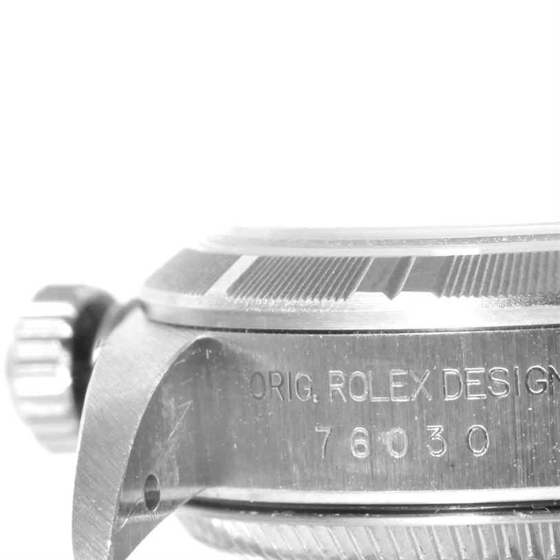 The image shows a close-up side view of a Rolex Oyster Perpetual 76030 Women's Stainless Steel Pink Dial 76030 Women's Stainless Steel Pink Dial watch's bezel, crown, and engraved case with model number 76030.