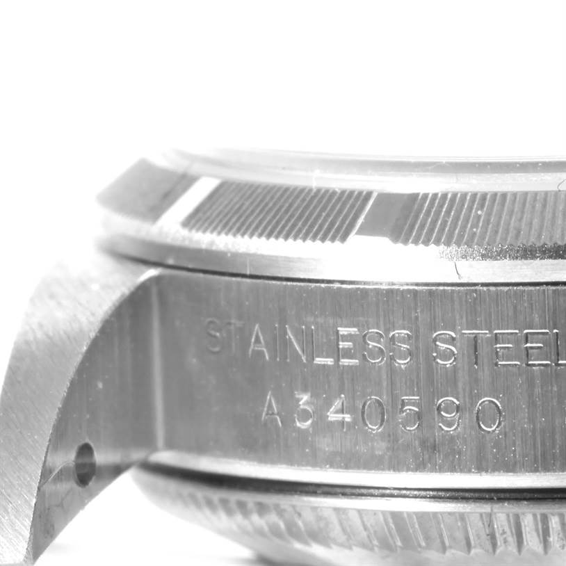 This image shows a close-up side view of the stainless steel case and serial number of a Rolex Oyster Perpetual 76030 Women's Stainless Steel Pink Dial 76030 Women's Stainless Steel Pink Dial watch.