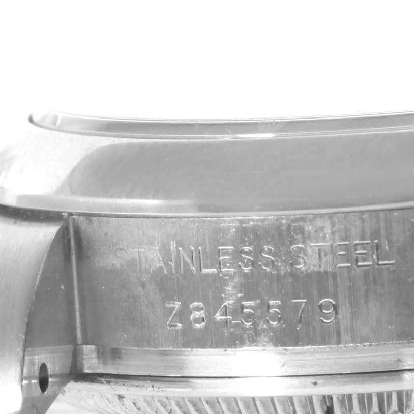 The image shows a close-up side view of the stainless steel case and part of the bezel of the Rolex Oyster Perpetual 176200 Women's Stainless Steel Black Dial 176200 Women's Stainless Steel Black Dial watch.