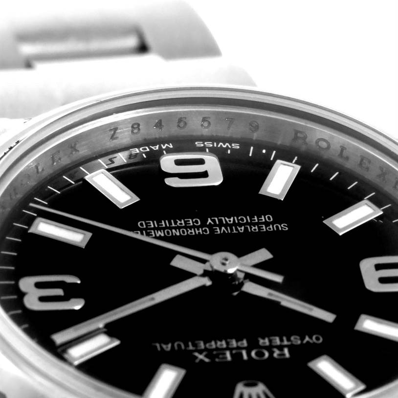 Close-up of the Rolex Oyster Perpetual 176200 Women's Stainless Steel Black Dial 176200 Women's Stainless Steel Black Dial watch showing part of the dial, bezel, and part of the bracelet.