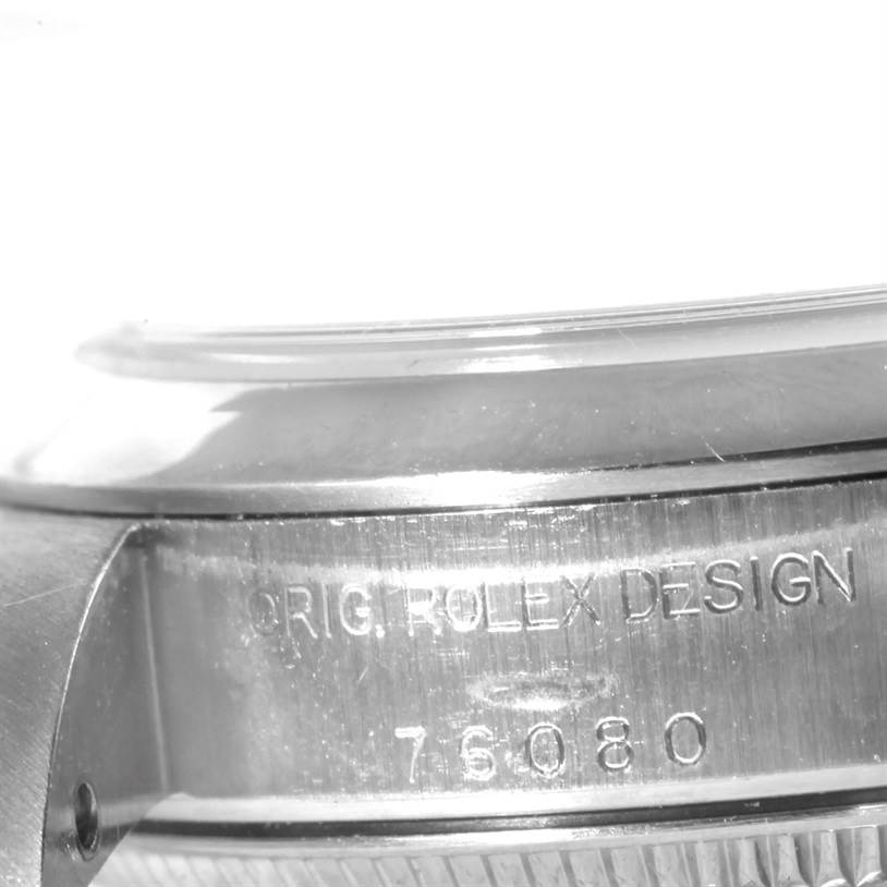 This image shows the side view of a Rolex Oyster Perpetual 76080 Women's Stainless Steel Pink Dial 76080 Women's Stainless Steel Pink Dial watch, highlighting the engraving on the case.