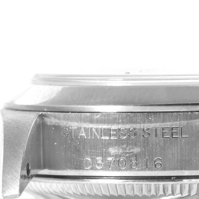 The image shows a side view of the stainless steel case and part of the bezel of a Rolex Oyster Perpetual 76080 Women's Stainless Steel Pink Dial 76080 Women's Stainless Steel Pink Dial watch.