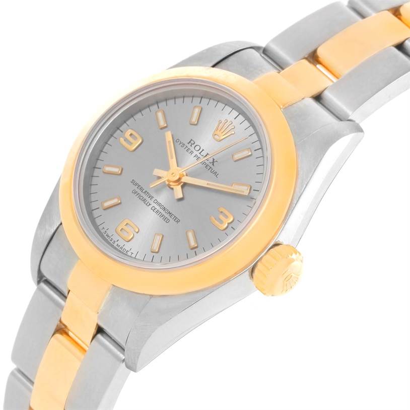 The Rolex Oyster Perpetual 67183 Women's Steel and Gold (two tone) Grey Dial 67183 Women's Steel and Gold (two tone) Grey Dial watch is shown at an angle highlighting its dial, crown, case, and two-tone bracelet.