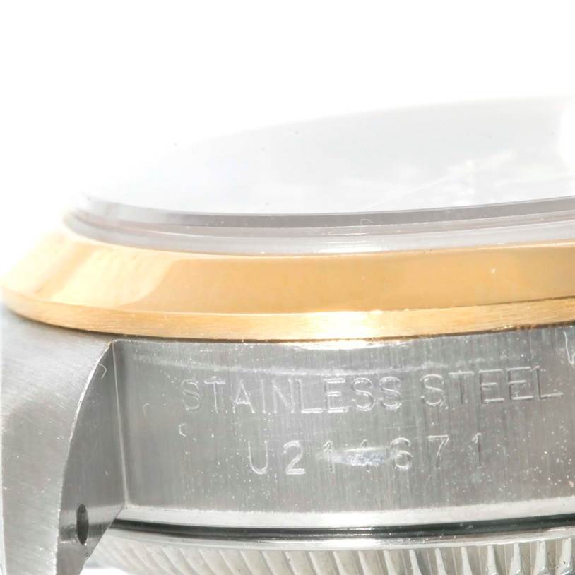 This close-up image shows the bezel, crystal, and side case with engraving details of a Rolex Oyster Perpetual 67183 Women's Steel and Gold (two tone) Grey Dial 67183 Women's Steel and Gold (two tone) Grey Dial watch.