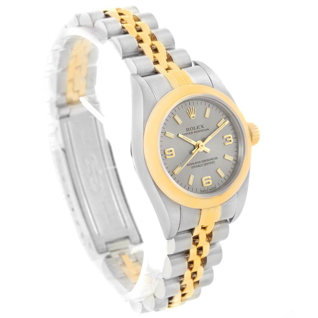 The image displays a Rolex Oyster Perpetual 76183 Women's Steel and Gold (two tone) Grey Dial 76183 Women's Steel and Gold (two tone) Grey Dial watch from an angled side view, showcasing its two-tone bracelet, bezel, and dial.