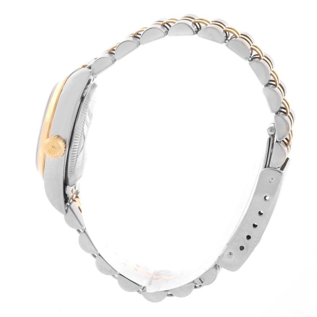 This side view of the Rolex Oyster Perpetual 76183 Women's Steel and Gold (two tone) Grey Dial 76183 Women's Steel and Gold (two tone) Grey Dial watch shows the crown, case, and two-tone bracelet.