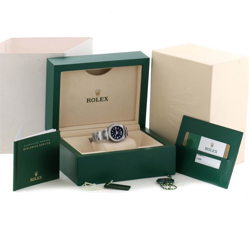 The image shows a Rolex Oyster Perpetual 176200 Women's Stainless Steel Black Dial 176200 Women's Stainless Steel Black Dial watch in its box, accompanied by warranty cards, a manual, and a green Rolex case.