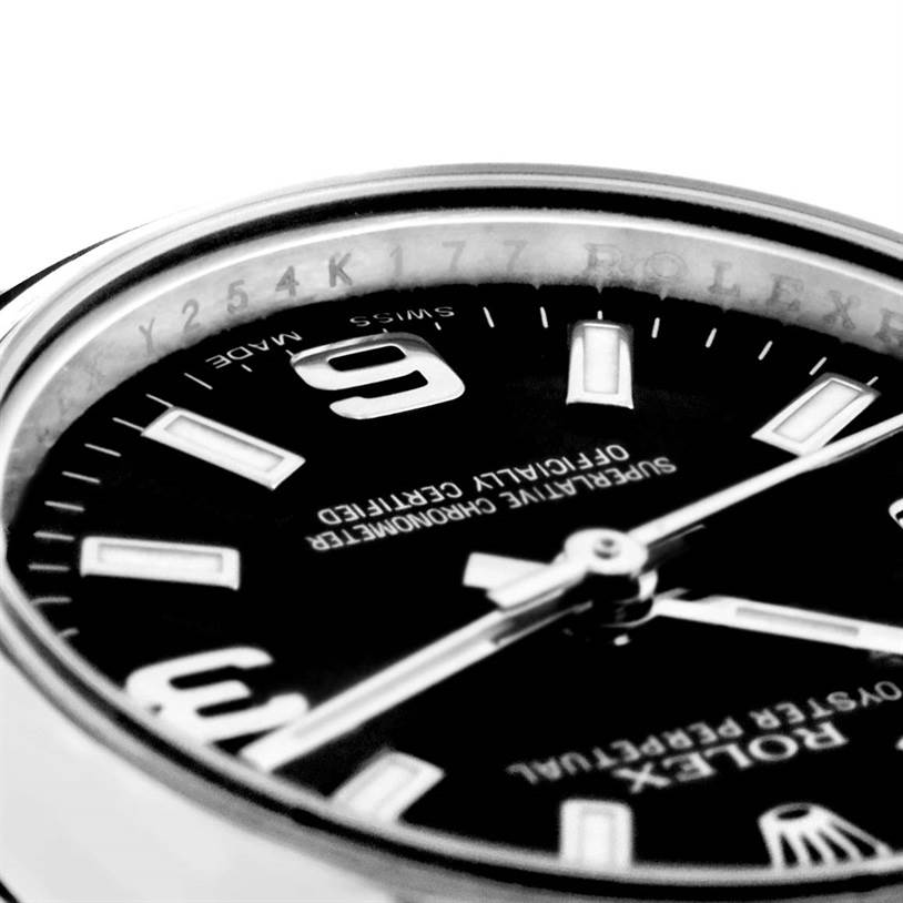 The image shows a close-up, angled view of a Rolex Oyster Perpetual 176200 Women's Stainless Steel Black Dial 176200 Women's Stainless Steel Black Dial watch dial and part of the bezel.