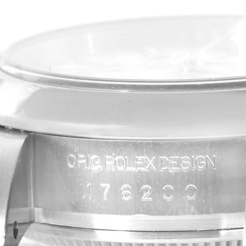 The image shows a close-up of the side of a Rolex Oyster Perpetual 176200 Women's Stainless Steel White Dial 176200 Women's Stainless Steel White Dial watch, highlighting the bezel and engraved model information.