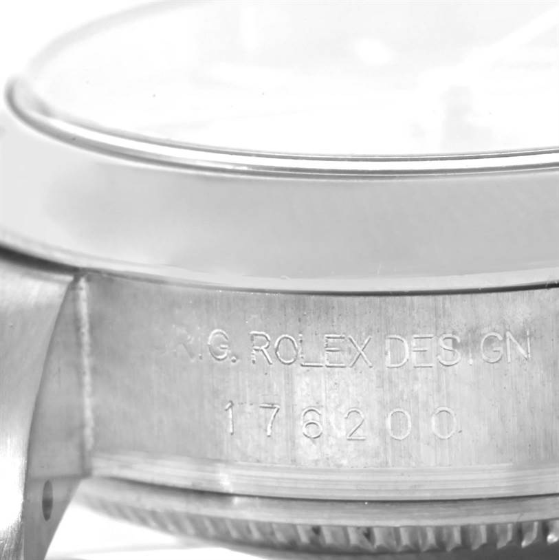 The image shows a close-up side view of the Rolex Oyster Perpetual 176200 Women's Stainless Steel Pink Dial 176200 Women's Stainless Steel Pink Dial model, focusing on the case with engravings visible.