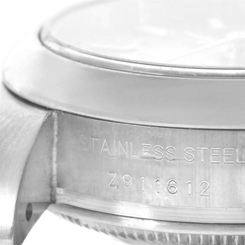 This image shows a close-up side angle of the case, bezel, and part of the crystal of a Rolex Oyster Perpetual 176200 Women's Stainless Steel Pink Dial 176200 Women's Stainless Steel Pink Dial watch.