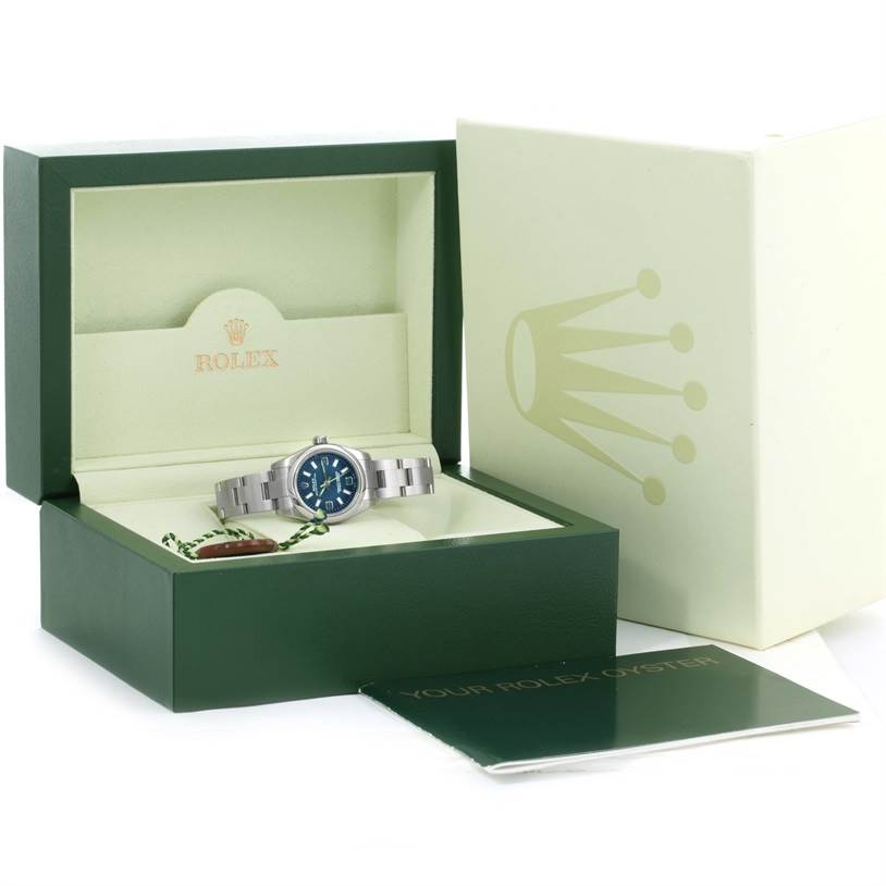 The image shows a Rolex Oyster Perpetual 176200 Women's Stainless Steel Blue Dial 176200 Women's Stainless Steel Blue Dial watch in its open green box, alongside its outer box and a booklet.