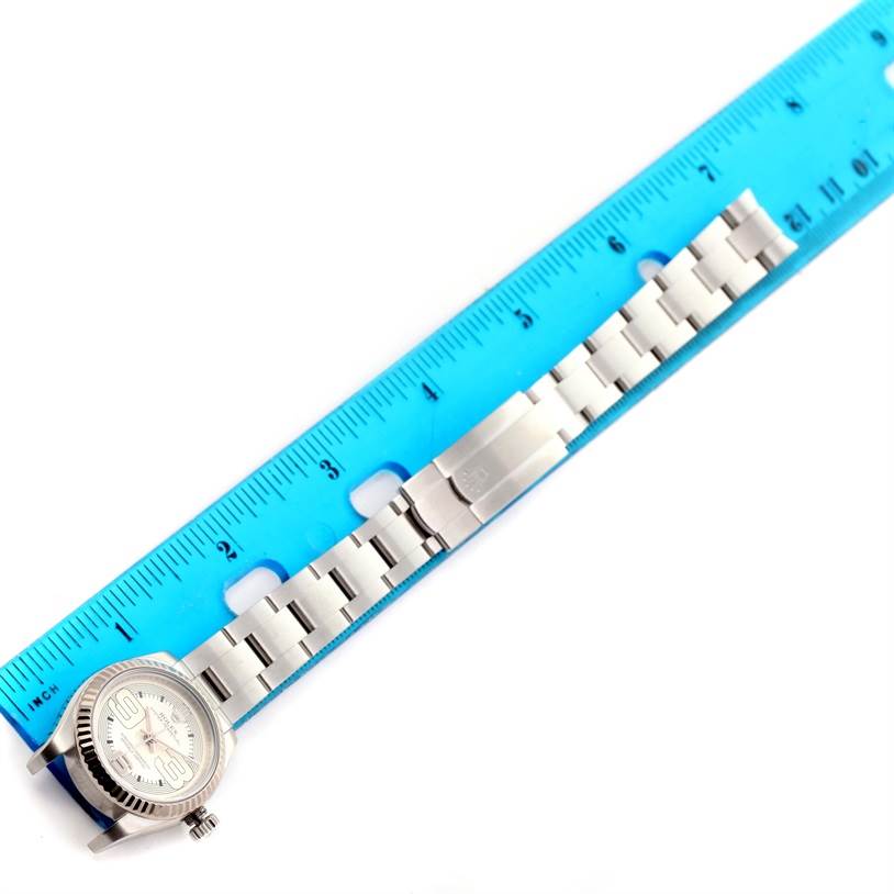 The image shows the full length of a Rolex Oyster Perpetual 176234 Women
s Stainless Steel Silver Dial 176234 Women
s Stainless Steel Silver Dial watch laid alongside a blue ruler.